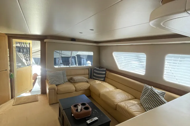 Slide: The Image of Luxurious interior of 1997 Hatteras 65 Convertible yacht with beige leather seating. - 3