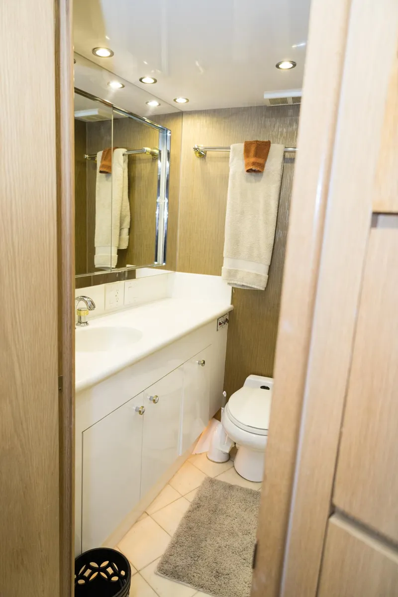 Slide: The Image of Bathroom interior of 1997 Hatteras 65 Convertible yacht, featuring modern fixtures and elegant design. - 30