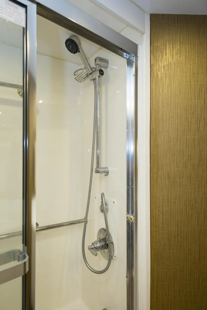 Slide: The Image of Shower area in 1997 Hatteras 65 Convertible yacht with modern fixtures. - 32