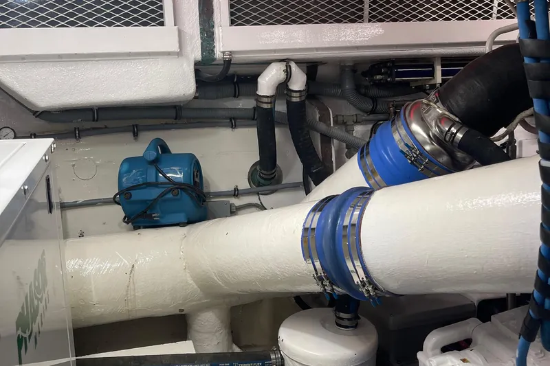 Slide: The Image of Engine room of 1997 Hatteras 65 Convertible yacht with pipes and machinery. - 43