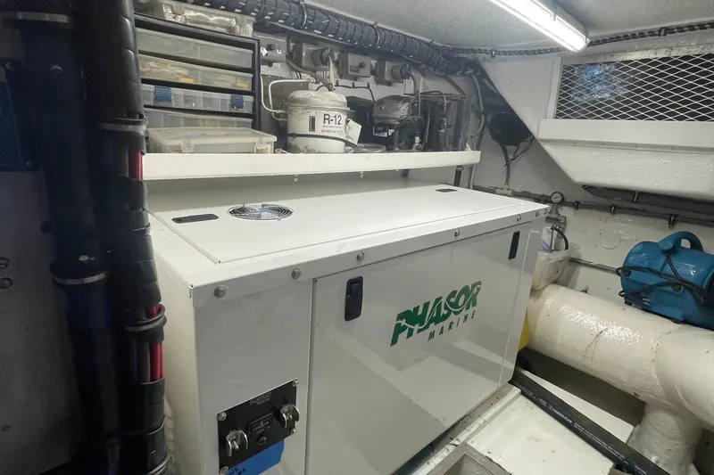 Slide: The Image of Engine room of 1997 Hatteras 65 Convertible with Phasor Marine generator. - 48