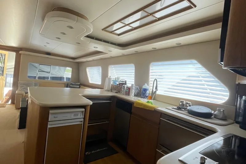 Slide: The Image of Interior of 1997 Hatteras 65 Convertible yacht with modern kitchen and seating area. - 49