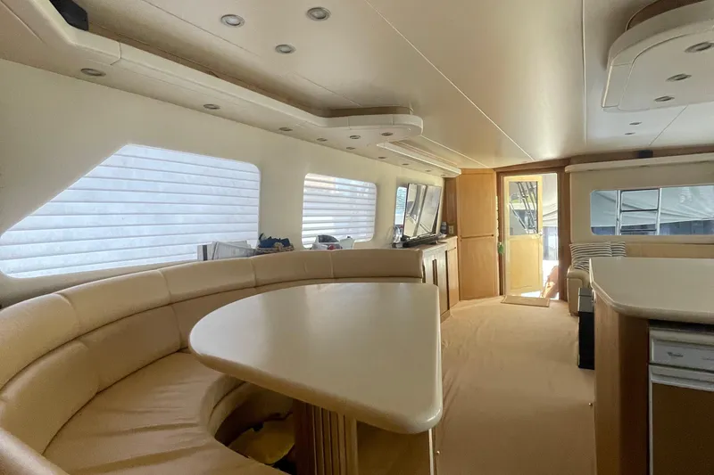 Slide: The Image of Interior of 1997 Hatteras 65 Convertible yacht with beige seating and modern amenities. - 5
