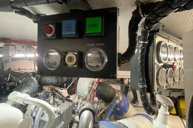 Slide: The Image of Engine room of 1997 Hatteras 65 Convertible with control panels and gauges. - 51