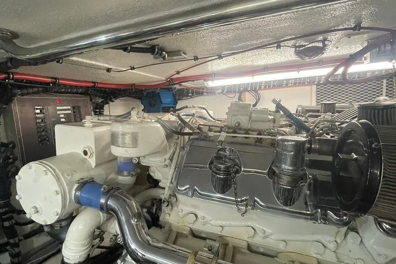 Slide: The Image of Engine room of a 1997 Hatteras 65 Convertible yacht, showcasing detailed machinery. - 54