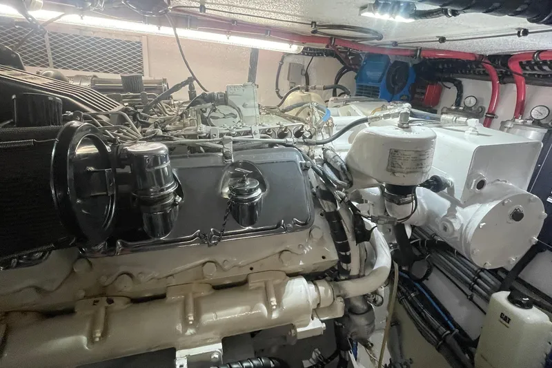 Slide: The Image of Engine room of a 1997 Hatteras 65 Convertible yacht, showcasing detailed machinery. - 55