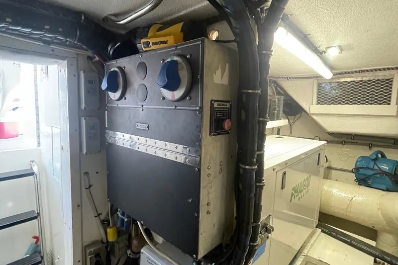Slide: The Image of Engine room of 1997 Hatteras 65 Convertible yacht with electrical panel and equipment. - 59