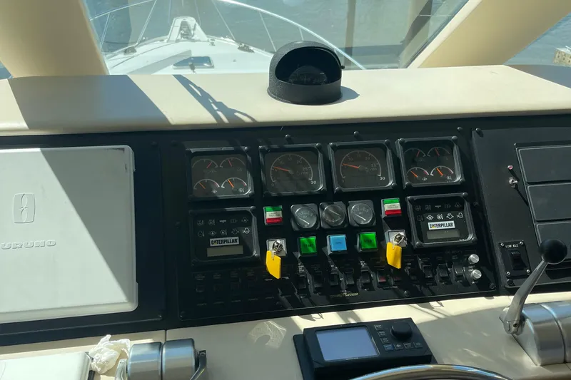 Slide: The Image of Control panel of a 1997 Hatteras 65 Convertible yacht with gauges and switches. - 61
