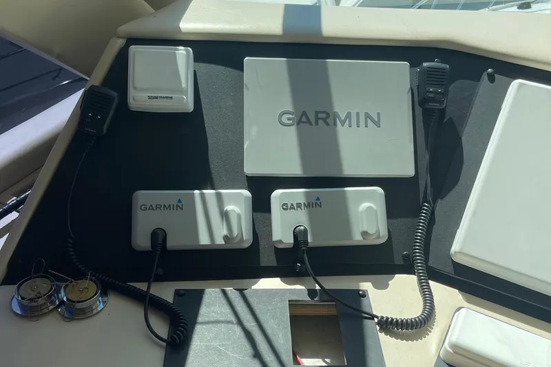 Slide: The Image of Control panel of a 1997 Hatteras 65 Convertible with Garmin navigation equipment. - 62