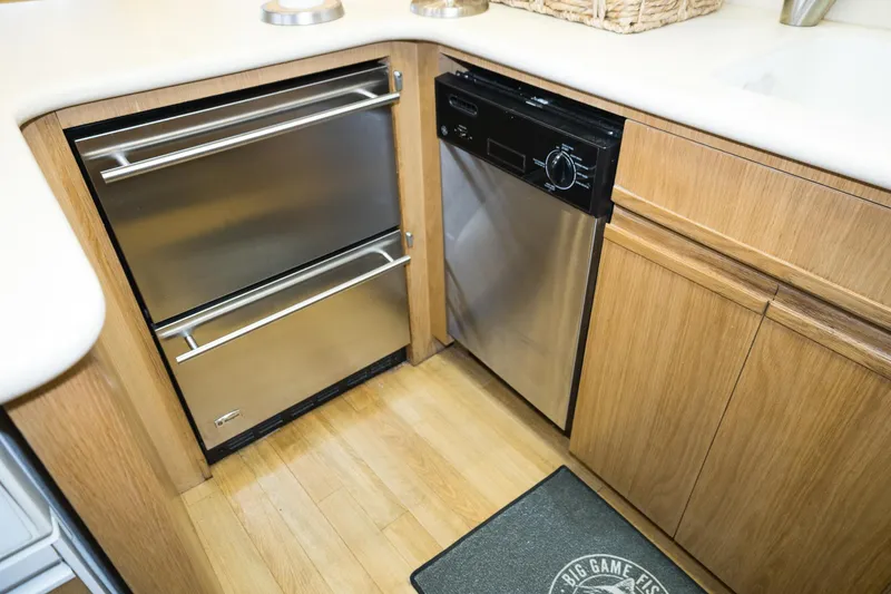 Slide: The Image of Kitchen area of 1997 Hatteras 65 Convertible yacht with stainless steel appliances. - 9