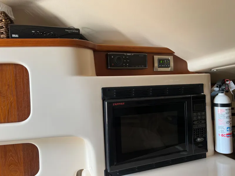 Slide: The Image of 2006 Grady-White 360 Express interior with microwave and fire extinguisher. - 13