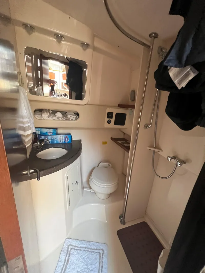 Slide: The Image of 2006 Grady-White 360 Express boat bathroom with shower, sink, and mirror. - 18
