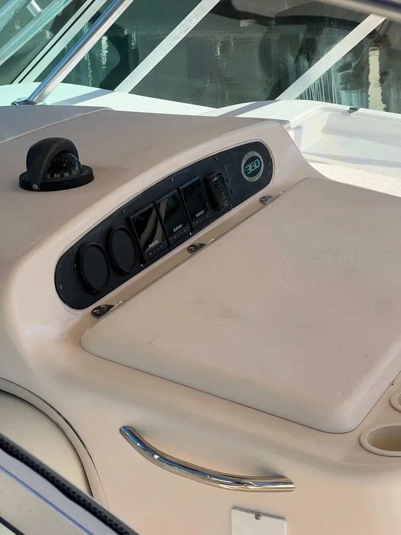 Slide: The Image of 2006 Grady-White 360 Express boat dashboard with control panel and compass. - 29