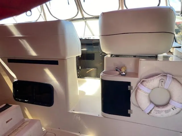 Slide: The Image of Interior of a 1990 Silverton 34 Express boat with seating and life preserver. - 10