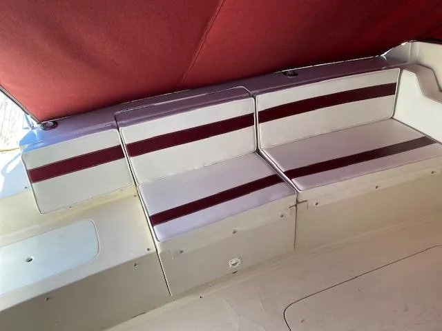 Slide: The Image of 1990 Silverton 34 Express boat interior with red and white seating. - 11