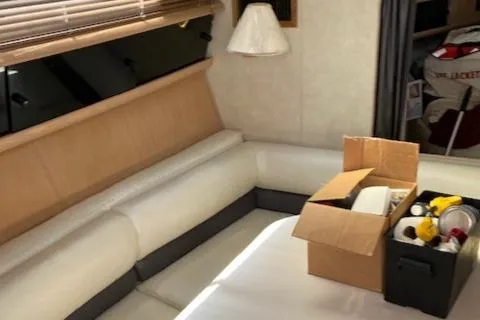 Slide: The Image of Interior of 1990 Silverton 34 Express boat with white seating and storage boxes. - 13