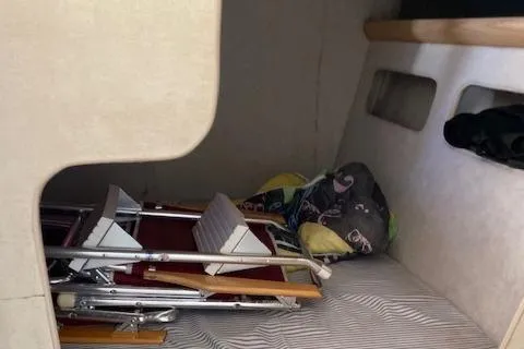 Slide: The Image of Interior cabin of a 1990 Silverton 34 Express boat with folded chairs and bedding. - 14