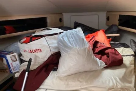 Slide: The Image of Interior cabin of a 1990 Silverton 34 Express boat with life jackets and gear. - 16