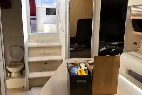 Slide: The Image of Interior of a 1990 Silverton 34 Express boat with stairs, bathroom, and seating area. - 17