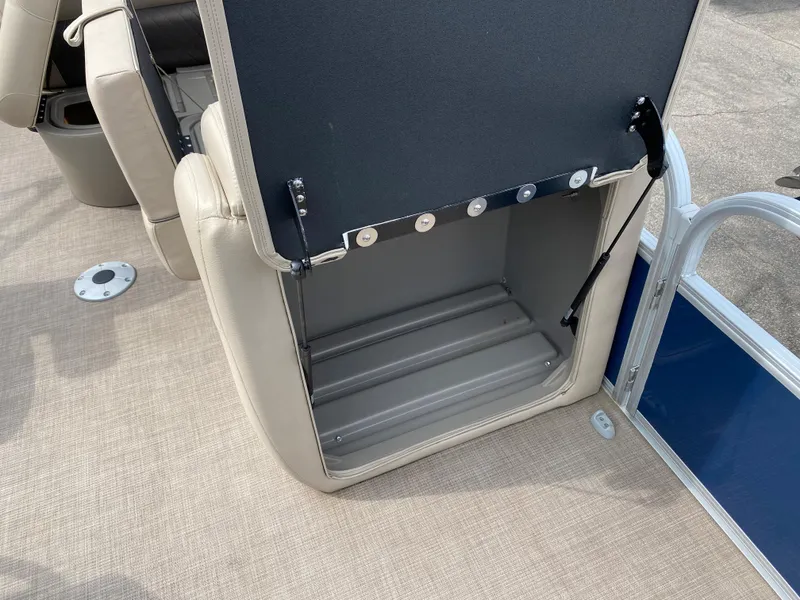 Slide: The Image of 2020 Sun Tracker SportFish 22 DLX storage compartment with open seat. - 24