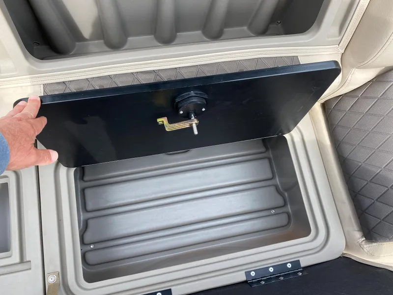 Slide: The Image of Sun Tracker SportFish 22 DLX 2020 storage compartment with open lid. - 25