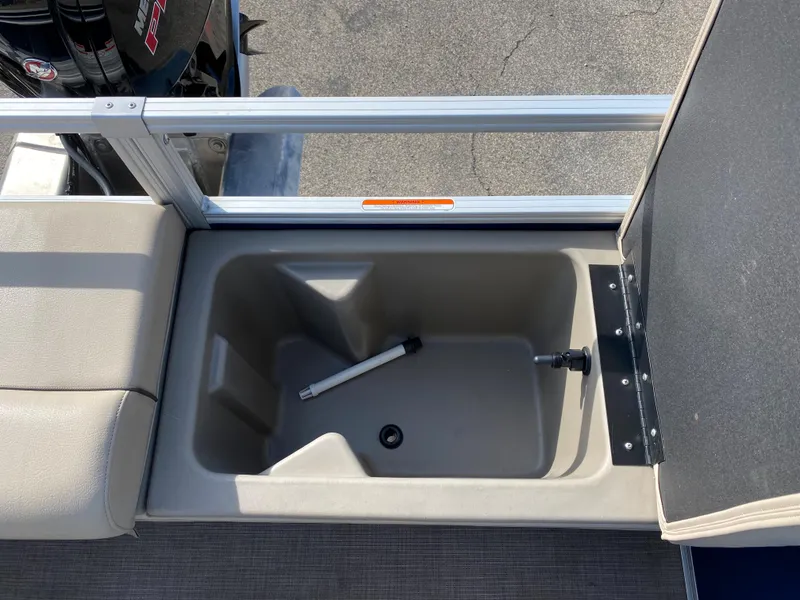Slide: The Image of 2020 Sun Tracker SportFish 22 DLX storage compartment with open lid. - 27