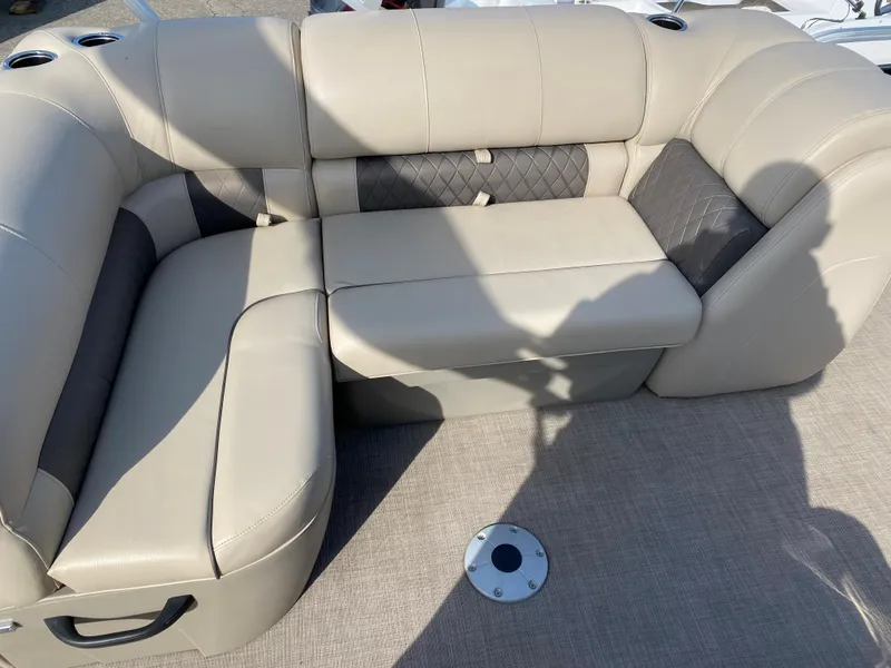 Slide: The Image of 2020 Sun Tracker SportFish 22 DLX boat seating area with beige and gray upholstery. - 4