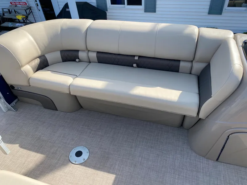 Slide: The Image of 2020 Sun Tracker SportFish 22 DLX boat with beige cushioned seating. - 8