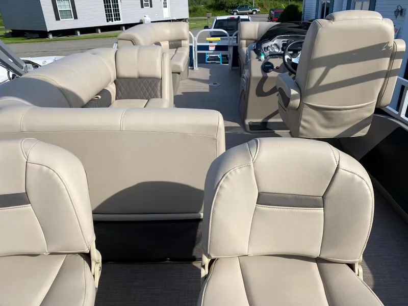Slide: The Image of 2020 Sun Tracker SportFish 22 DLX pontoon boat interior with beige seating. - 9