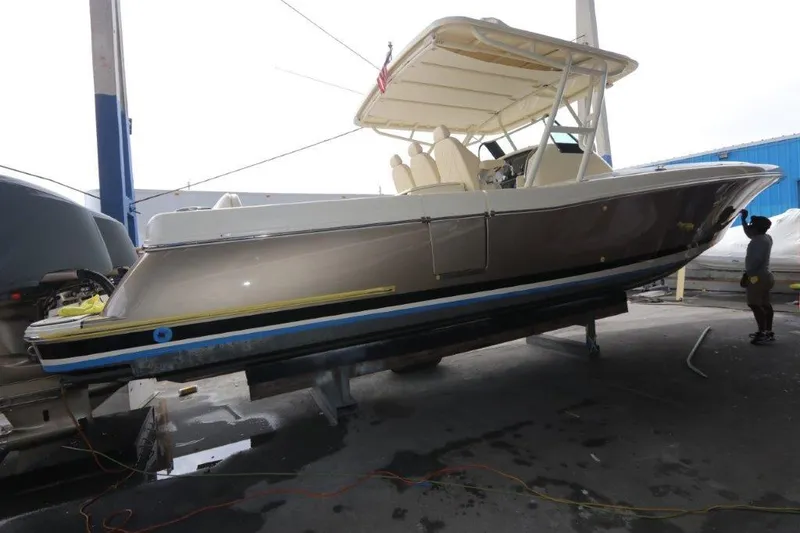 Slide: The Image of 2017 Chris-Craft 35 Catalina boat on a lift in a marina. - 16