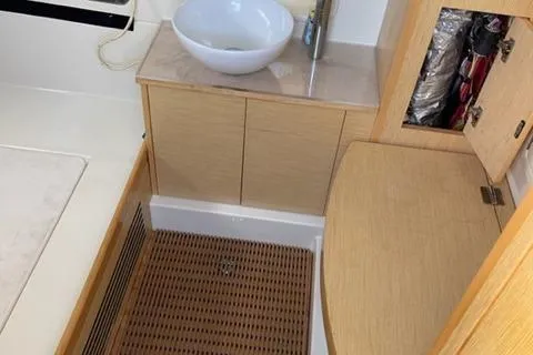 Slide: The Image of 2017 Chris-Craft 35 Catalina bathroom with wooden cabinetry and modern sink. - 8