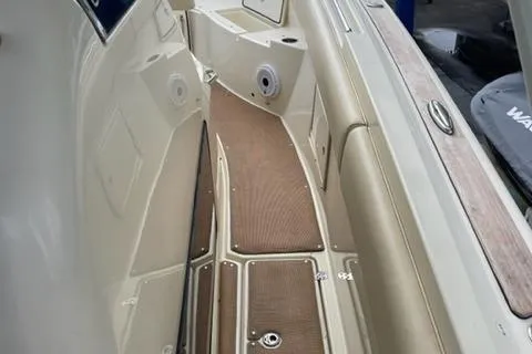 Slide: The Image of 2017 Chris-Craft 35 Catalina boat deck with tan flooring and storage compartments. - 9