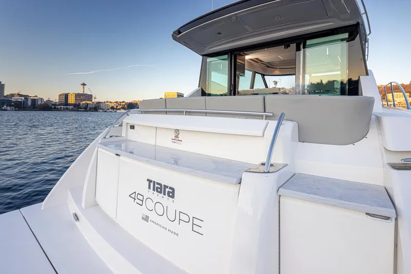 Slide: The Image of 2023 Tiara Yachts 49 COUPE on water, showcasing sleek design and modern features. - 14