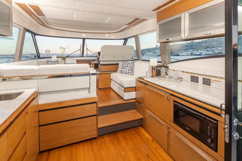 Slide: The Image of Luxurious interior of 2023 Tiara Yachts 49 COUPE with modern kitchen and seating area. - 16