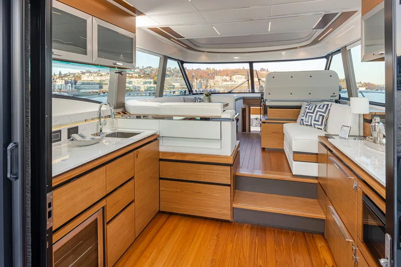 Slide: The Image of Luxurious interior of 2023 Tiara Yachts 49 COUPE with modern wood finishes and panoramic windows. - 17