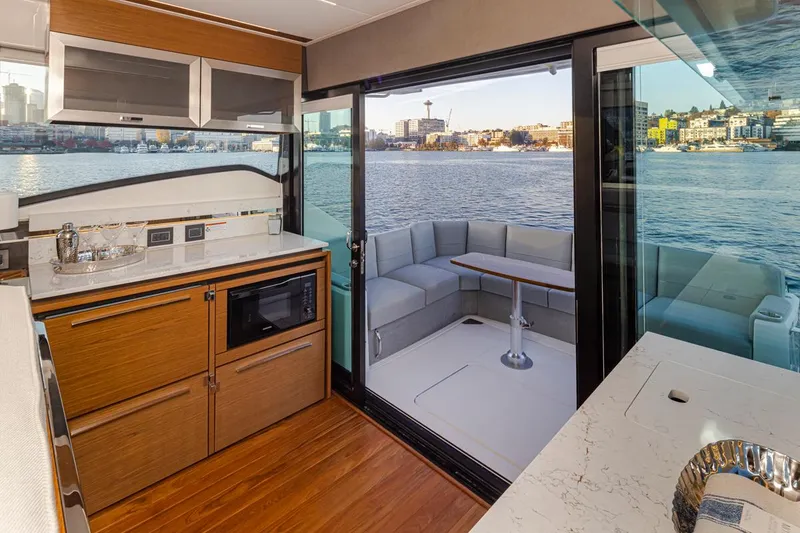 Slide: The Image of Luxurious 2023 Tiara Yachts 49 COUPE interior with modern kitchen and waterfront view. - 22