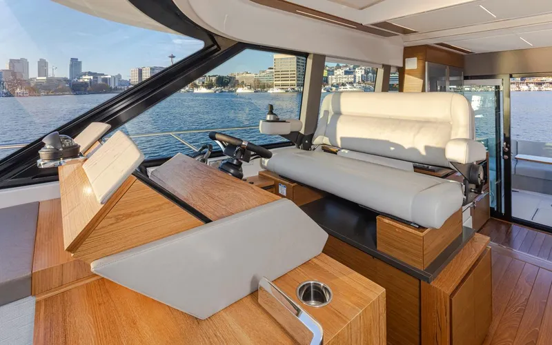 Slide: The Image of Interior helm of 2023 Tiara Yachts 49 COUPE with waterfront view. - 26