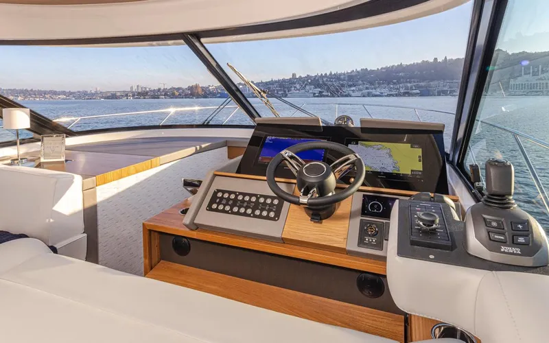 Slide: The Image of 2023 Tiara Yachts 49 COUPE helm with modern navigation system and panoramic view. - 29