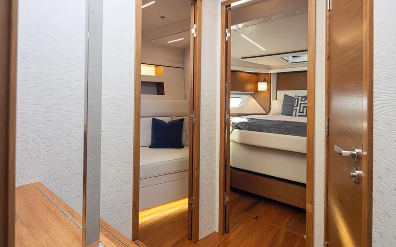 Slide: The Image of Luxurious interior of 2023 Tiara Yachts 49 COUPE with modern bedroom and seating area. - 30