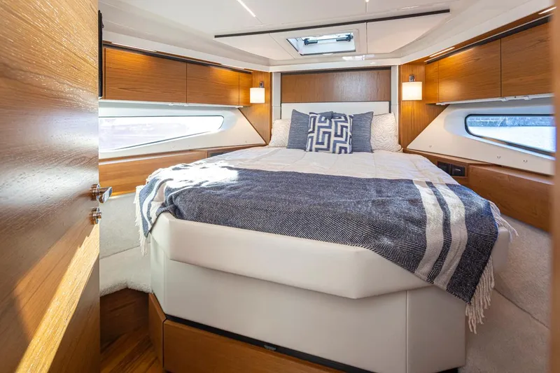 Slide: The Image of Luxurious bedroom interior of 2023 Tiara Yachts 49 COUPE with elegant wood finishes. - 31