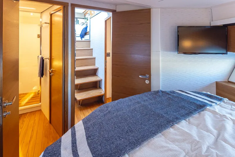 Slide: The Image of Interior of 2023 Tiara Yachts 49 COUPE, featuring bedroom, stairs, and bathroom. - 32
