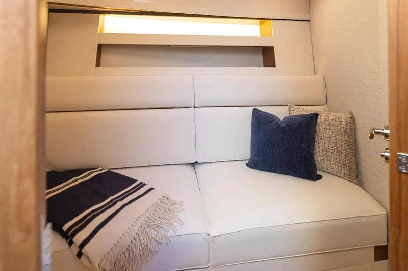 Slide: The Image of Luxurious interior of 2023 Tiara Yachts 49 COUPE with cozy seating and decorative pillows. - 33