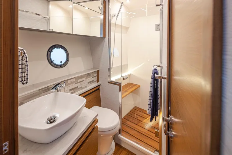 Slide: The Image of Luxurious bathroom in 2023 Tiara Yachts 49 COUPE with modern fixtures and wooden accents. - 34