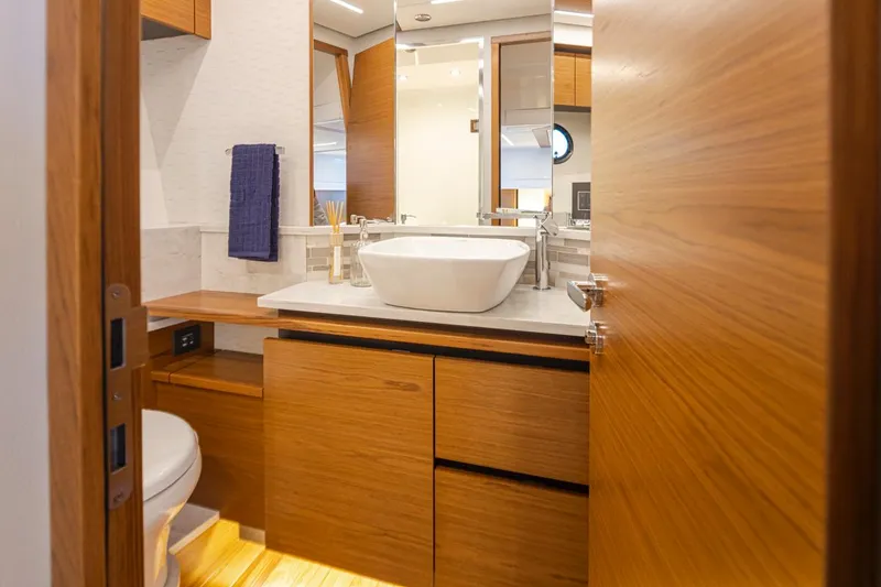 Slide: The Image of Luxurious bathroom in 2023 Tiara Yachts 49 COUPE with modern fixtures and wooden cabinetry. - 40