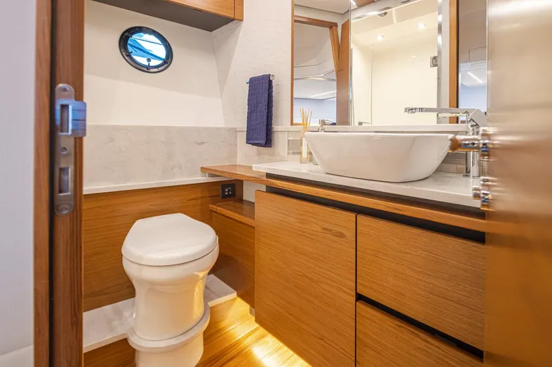 Slide: The Image of Luxurious bathroom in 2023 Tiara Yachts 49 COUPE with modern fixtures and wood accents. - 41