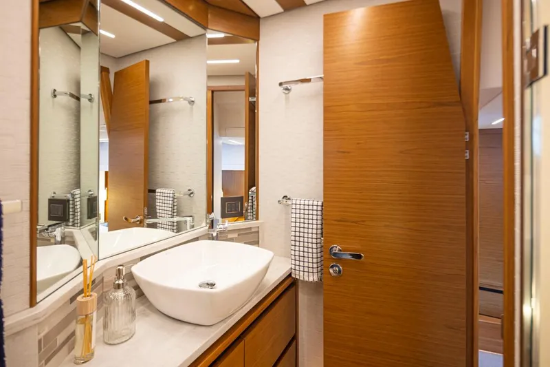 Slide: The Image of Luxurious bathroom in 2023 Tiara Yachts 49 COUPE with modern sink and wooden accents. - 42