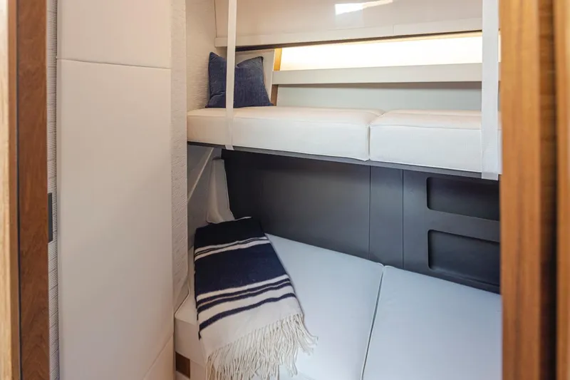 Slide: The Image of 2023 Tiara Yachts 49 COUPE interior cabin with bunk beds and cozy decor. - 45