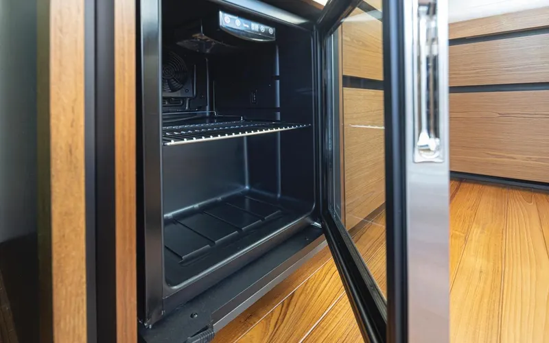 Slide: The Image of Open fridge in 2023 Tiara Yachts 49 COUPE, showcasing sleek interior design. - 46
