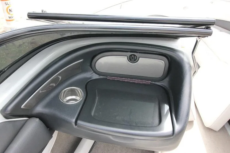 Slide: The Image of 2015 Crownline 21 SS boat interior storage compartment and cup holder. - 10