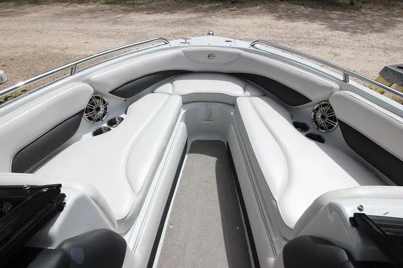 Slide: The Image of 2015 Crownline 21 SS boat interior with white seating and speakers. - 11